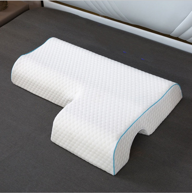 Two white orthopedic pillows with blue accents on a dark surface.